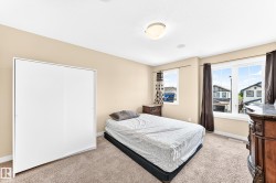 Laundry area featuring tiled flooring, a white paneled door, and a window with horizontal blinds - 
