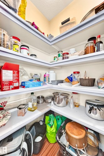 Corner pantry with multiple white shelves providing vertical storage - 2923 16 Street Nw, Edmonton, AB - Indoor With Storage