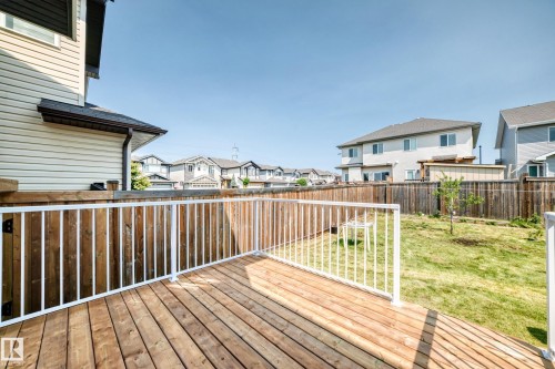 Expansive outdoor deck featuring natural wood planks and white railings - 2923 16 Street Nw, Edmonton, AB - Outdoor With Deck Patio Veranda With Exterior