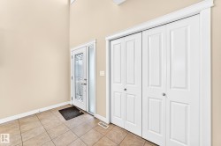 Entryway featuring a decorative glass front door, transom window, and sidelight - 