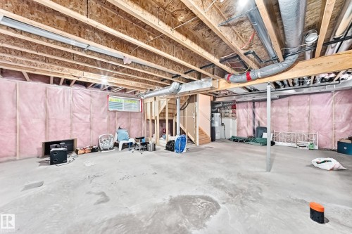 Unfinished basement featuring exposed wood joists, concrete flooring, and insulated walls - 2923 16 Street Nw, Edmonton, AB - Indoor Photo Showing Basement