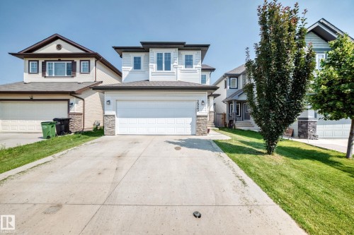 Modern home exterior featuring light-toned siding with dark trim accents and stone veneer detailing - 2923 16 Street Nw, Edmonton, AB - Outdoor With Facade