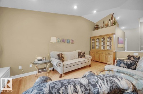 Spacious living area featuring vaulted ceilings, recessed lighting, and wood-finish flooring - 928 Thompson Place Nw, Edmonton, AB - Indoor Photo Showing Living Room