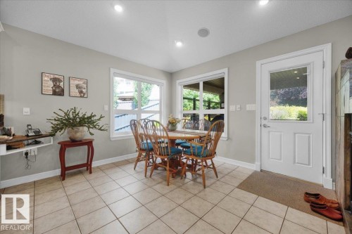 Bright dining space featuring tile flooring, recessed lighting, and two large windows - 928 Thompson Place Nw, Edmonton, AB - Indoor Photo Showing Dining Room