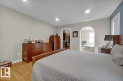 Recessed lighting illuminating wood-finish flooring - 