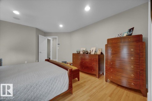 Bedroom featuring light wood-finish flooring, recessed lighting, and neutral wall tones - 928 Thompson Place Nw, Edmonton, AB - Indoor Photo Showing Bedroom