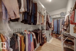 Customizable closet organization system featuring multiple hanging rods and built-in shelving units - 