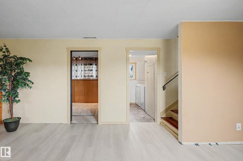 Light wood-finish flooring throughout the space - 9516 129A Avenue Nw, Edmonton, AB - Indoor Photo Showing Other Room