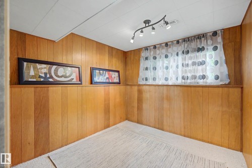 Room featuring wood paneling, a drop ceiling, and track lighting - 9516 129A Avenue Nw, Edmonton, AB - Indoor Photo Showing Other Room