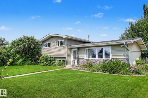 Split-level residence featuring siding and stone veneer exterior - 9516 129A Avenue Nw, Edmonton, AB - Outdoor