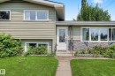 Split-level residence featuring a textured siding exterior and a stone veneer accent wall - 9516 129A Avenue Nw, Edmonton, AB  - Outdoor 