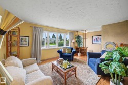 Living area featuring natural wood-finish flooring and a decorative area rug - 