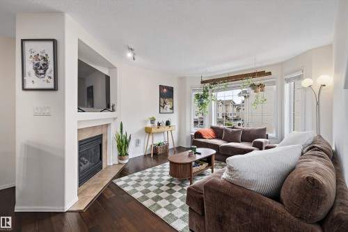 #20 1295 Carter Crest Rd Nw, Edmonton, AB - Indoor Photo Showing Living Room With Fireplace