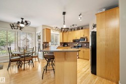 Kitchen with wood-finish flooring and light wood cabinetry - 