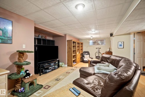 Finished basement living area featuring neutral wall colors, drop ceiling, and recessed lighting - 416 Sparling Crest Sw, Edmonton, AB - Indoor