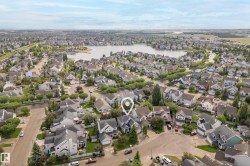 Aerial perspective showcasing a residential neighborhood with a large body of water - 