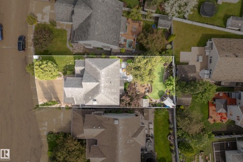 Aerial perspective showcasing a property with a distinct roofline, a paved driveway, and a verdant lawn - 416 Sparling Crest Sw, Edmonton, AB - 