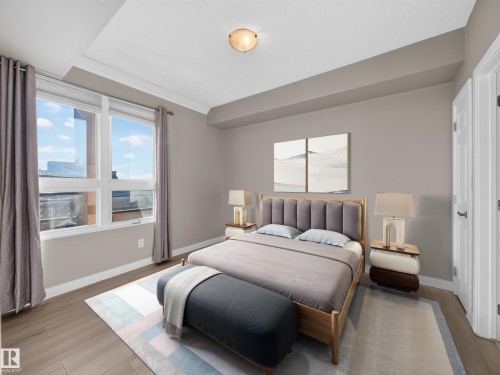 Spacious room featuring wood-finish flooring and a large window with white framing - #1208 9939 109 St Nw, Edmonton, AB - Indoor Photo Showing Bedroom
