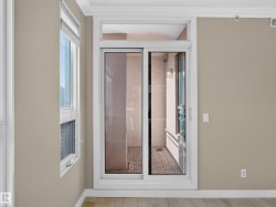 Glass sliding door providing access to an exterior space with brick-patterned flooring - 
