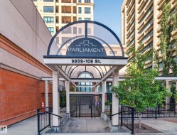 Building entrance featuring a glass-covered archway, "Parliament" signage, and street address - 