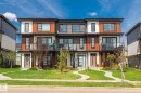 Contemporary multi-story townhomes featuring contrasting horizontal siding in white, wood-tone, and charcoal - 8282 Chappelle Way Sw, Edmonton, AB  - Outdoor With Facade 