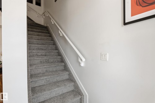 Carpeted staircase with light gray pile and white handrails - 8282 Chappelle Way Sw, Edmonton, AB - Indoor Photo Showing Other Room