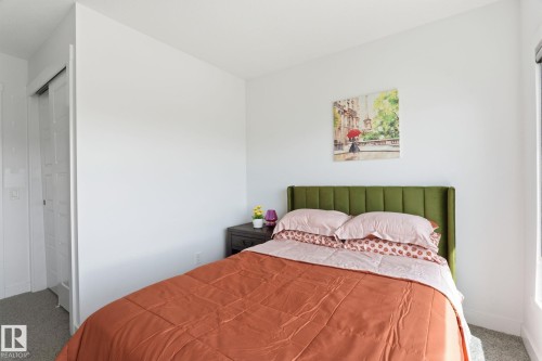 Bright room featuring a window for natural light, neutral wall colors, and gray carpeting - 8282 Chappelle Way Sw, Edmonton, AB - Indoor Photo Showing Bedroom