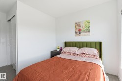 Bright room featuring a window for natural light, neutral wall colors, and gray carpeting - 