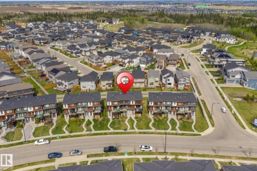 Contemporary townhome community featuring multi-level residences with contrasting facades and individual balconies - 8282 Chappelle Way Sw, Edmonton, AB - Outdoor With View