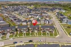 Contemporary townhome community featuring multi-level residences with contrasting facades and individual balconies - 