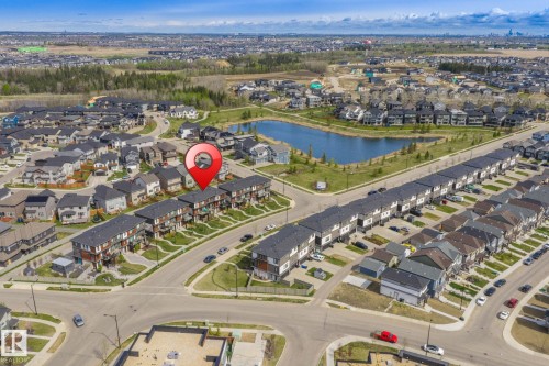 Aerial perspective showcasing a residential area with a prominent water feature - 8282 Chappelle Way Sw, Edmonton, AB - Outdoor With View