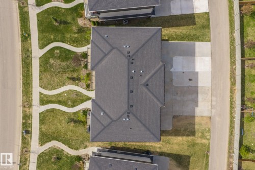 Gabled roofline with dark shingles, featuring multiple roof vents and a front-facing driveway - 8282 Chappelle Way Sw, Edmonton, AB - Outdoor