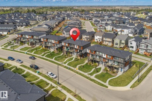 Modern multi-story residential building with private balconies and dark-pitched roofs - 8282 Chappelle Way Sw, Edmonton, AB - Outdoor With View