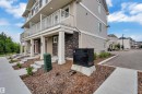 Multi-level townhome exterior with horizontal siding and stone accents - #64 17832 78 St Nw Nw, Edmonton, AB  - Outdoor With Balcony 