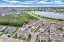 Aerial perspective showcasing a residential community with townhomes and detached properties - #64 17832 78 St Nw Nw, Edmonton, AB  - Outdoor With Body Of Water With View 