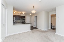 Open-concept living area featuring light-toned carpeting and neutral wall colors - 