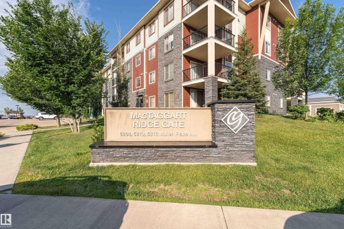 Multi-story building featuring stone and siding exterior accents - #322 5816 Mullen Pl Nw, Edmonton, AB - Outdoor