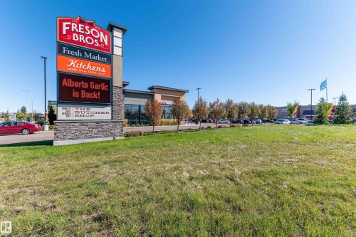 Retail pylon sign with a stone base and multiple tenant panels - #322 5816 Mullen Pl Nw, Edmonton, AB - Outdoor