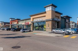 Modern retail facade featuring stone accents and varied exterior finishes - 