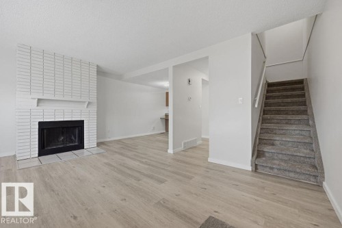 10473 24 Avenue Nw, Edmonton, AB - Indoor Photo Showing Living Room With Fireplace