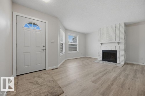 10473 24 Avenue Nw, Edmonton, AB - Indoor Photo Showing Living Room With Fireplace