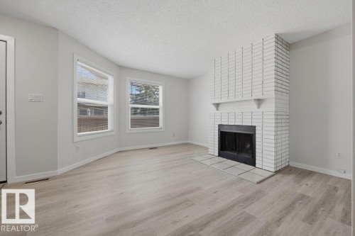 10473 24 Avenue Nw, Edmonton, AB - Indoor Photo Showing Living Room With Fireplace