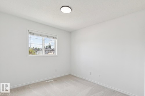 Windowed room featuring light-toned carpeting and a white ceiling with a flush-mount light fixture - 64 Foxboro Link, Sherwood Park, AB - Indoor Photo Showing Other Room
