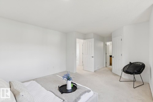 Spacious room featuring clean white walls, light-colored carpeting, multiple white panel doors, and recessed ceiling lighting - 64 Foxboro Link, Sherwood Park, AB - Indoor