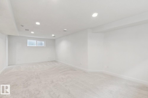 Spacious room featuring light-colored carpeting, white painted walls, and recessed lighting - 64 Foxboro Link, Sherwood Park, AB - Indoor