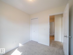 Neutral-toned wall paint and light gray carpeting create a versatile interior space - 