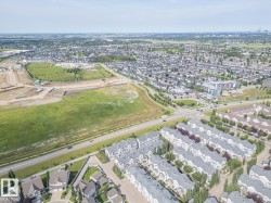 Aerial perspective showcasing a residential community with varying housing types - 
