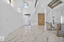 Spacious entryway featuring high ceilings, large format marble-look tile flooring, and a modern chandelier - 11 Harley Way, Spruce Grove, AB  - Indoor Photo Showing Other Room 