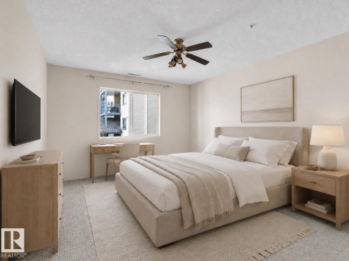 Recessed ceiling lighting complements the central ceiling fan - #224 16303 95 St Nw, Edmonton, AB - Indoor Photo Showing Bedroom