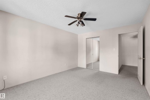 Bedroom featuring light grey carpeting, white walls, and a textured white ceiling - #224 16303 95 St Nw, Edmonton, AB - Indoor Photo Showing Other Room